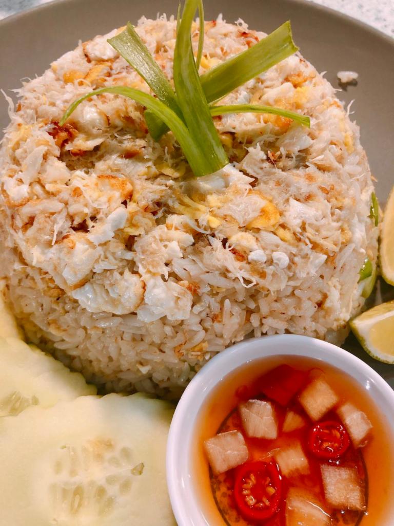 P1. Crab Fried Rice · (GF*)Fried rice topped with egg, stir fried with crab meat and chopped green onion. 
Served with cucumber ,cilantro, lime and chili fish sauce on the side.