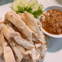 P3. Khao Mun Gai · Hainanese poached dark meat chicken and perfectly seasoned rice. Served with 
ginger sauce, ...
