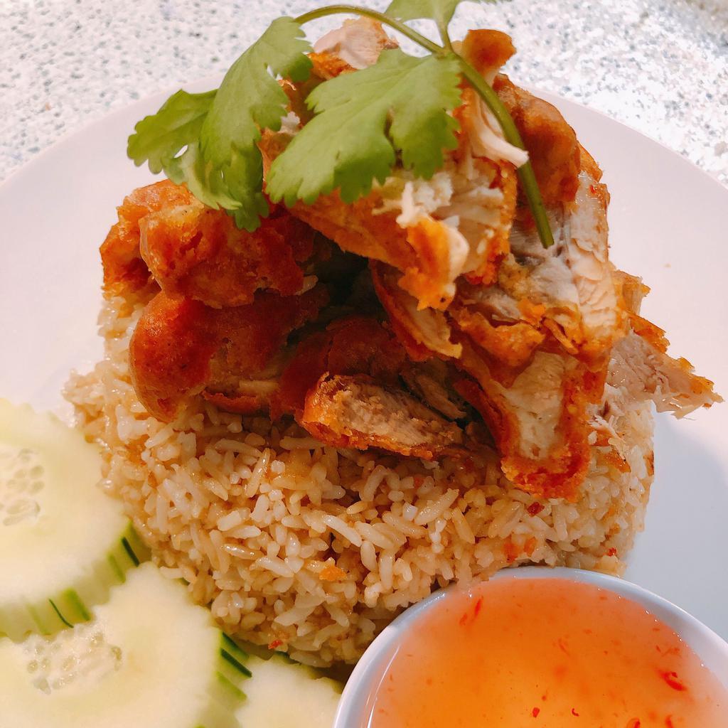 P4. Fried Khao Mun Gai · Deep fried Hainanese dark meat chicken and seasoned rice. Served with special sweet sour sauce, cucumber garnishes and a side of clear soup with green onion