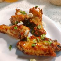 Sweet Sixteen · 5 wings. Thai style brown sauce, sweet and savory topped with chopped green onions.
