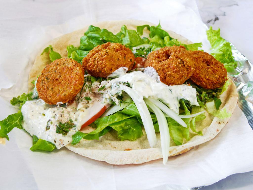 Falafel Wrap · Chick peas, garlic, onion, parley herbs and spices deep fried with vegetables and tahina dressing.