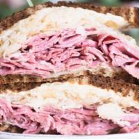 Classic Reuben Sandwich · Favorite. Corned beef, Swiss, 1000 island, sauerkraut, marble rye.