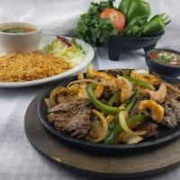Mixed Fajitas with Shrimp · Chicken and beef, sauteed with bell peppers and onions. Served on a sizzling hot plate.