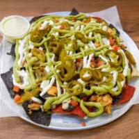 Cholitas Nachos · Crisp nachos topped with your choice of refried or black beans, pico de gallo, jalapenos, so...