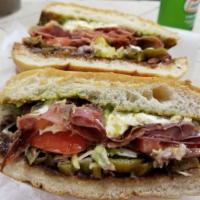 Hamon con Queso Torta (ham n cheese) · All tortas are made with refried beans, tomatoes, Oaxaca cheese, guacamole, jalapenos and le...