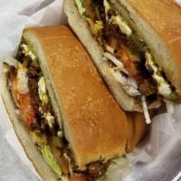 Chorizo Torta (ground pork sausage). · All tortas are made with refried beans, tomatoes, Oaxaca cheese, guacamole, jalapenos and le...
