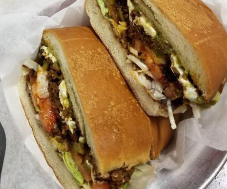 Chorizo Torta (ground pork sausage). · All tortas are made with refried beans, tomatoes, Oaxaca cheese, guacamole, jalapenos and lettuce.  