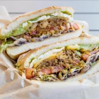 De Pierna Torta (pulled pork) · All tortas are made with refried beans, tomatoes, Oaxaca cheese, guacamole, jalapenos and le...
