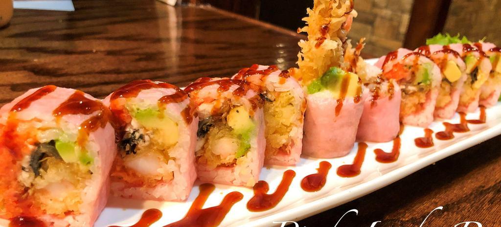 28. Pink Lady Roll · 10 pieces. Shrimp tempura, spicy tuna, avocado, eel with pink soy paper, eel sauce (soy paper).