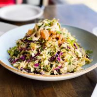 Asian Salad · Napa cabbage cilantro slaw, fried wonton strips, peanut soy vinaigrette. 