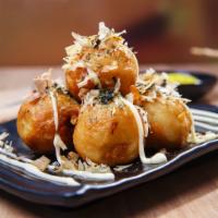 Takoyaki · 8 pieces Japanese octopus balls，top with Mayo,eel sauce ,seaweed,masago 