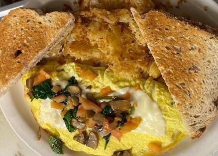 Veggie Omelette · Grilled Mushrooms, Onions, Spinach and Tomatoes with Provolone cheese, House made Hash Browns and White toast