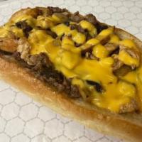 Ultimate Cheese Steak · Hand carved Ribeye  steak, grilled sweet onions, White american cheese and cheese sauce on a...
