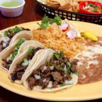 4 Mini Taco Lunch Special · Four mini tacos topped with onions, cilantro, and house green salsa and served with rice and...