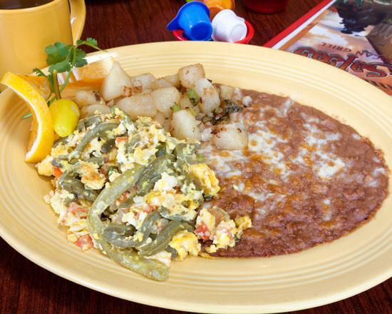 Nopales con Huevos · Cactus and eggs, sauteed onions, jalapenos and tomatoes, served with rice and beans or potatoes and beans.