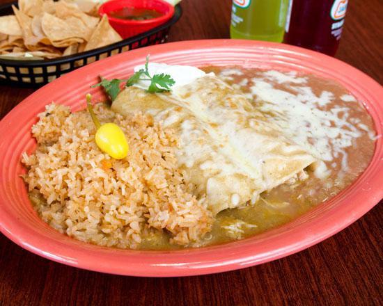 2 Enchiladas Suizas · Chicken enchiladas topped with chile verde sauce and garnished with sour cream. Served with rice and refried beans.