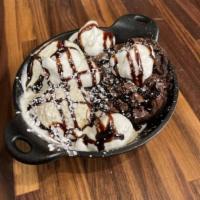 Fudge Brownie Skillet · Warm Fudge brownie served warm with two scoop of ice cream and Chocolate sauce topped with w...