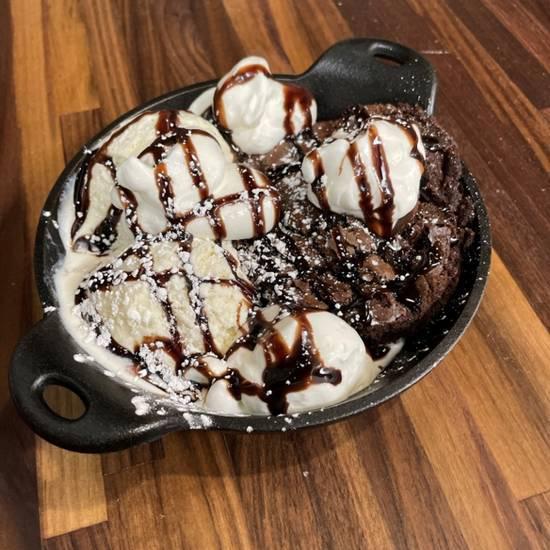 Fudge Brownie Skillet · Warm Fudge brownie served warm with two scoop of ice cream and Chocolate sauce topped with whipped cream