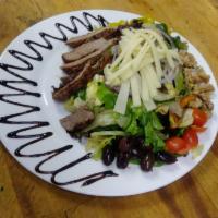 Steak Salad · Filet mignon over acadian greens served with kalamata olives, provolone cheese and an house ...