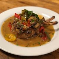 Double Thick Pork Chop · Pan seared and baked to perfection with sweet peppers, bell peppers, mushrooms, garlic, oreg...