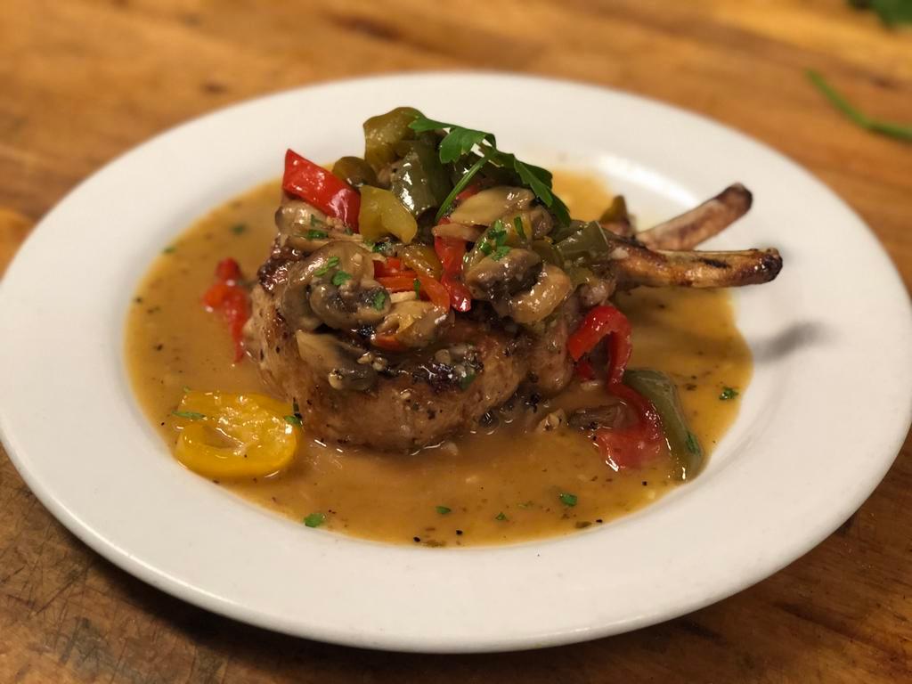 Double Thick Pork Chop · Pan seared and baked to perfection with sweet peppers, bell peppers, mushrooms, garlic, oregano and olive oil.