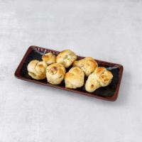 Garlic Knots · Served with a side of red sauce.