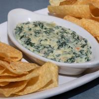 Three Cheese Spinach Dip · A creamy blend of fresh spinach, artichoke hearts, white American, parmesan, and romano chee...