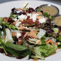 Harvest Salad · Mixed greens, chopped apples, dried cranberries, bacon, toasted almonds, and feta cheese. Se...