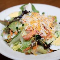 Traditional Salad · Mixed greens, tomatoes, cucumbers, cheddar-jack cheese, and hard boiled egg. Served with our...