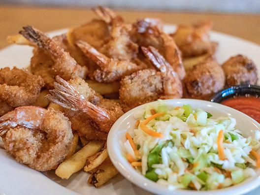 Shrimp Platter · Ten large shrimp battered in seasoned panko. Served with fresh made cocktail sauce. Served with crispy fries, homemade apple cider slaw, and jalapeño hush puppies.