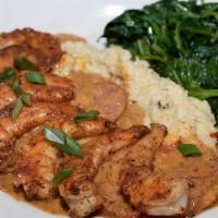 Shrimp and Grits · Large blackened shrimp on a bed of jalapeño cheese grits with smoked Andouille sausage gravy...