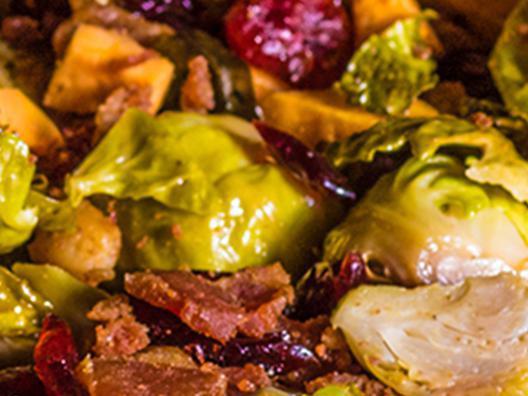Roasted Brussels Sprouts · Seasoned and roasted Brussels sprouts mixed with roasted carrots, bacon, and cranberries sautéed in garlic butter. (Contains Pork)