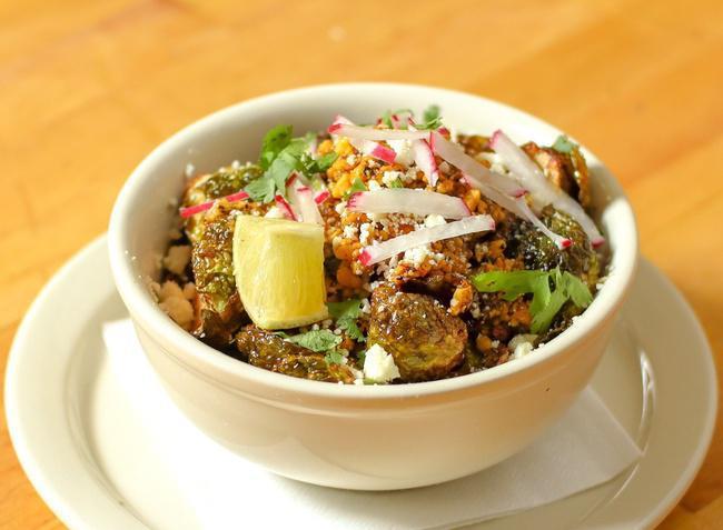 Crispy Brussels Sprouts · Brussels sprouts in a peanut-chili salsa with cotija cheese and radish.