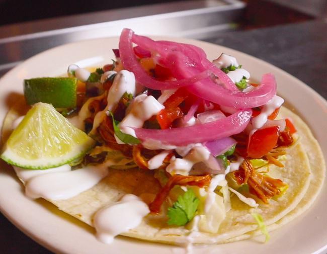 Chipotle Pork Taco · Slow-cooked pork in chipotle sauce with pickled red onions, pico de gallo and sour cream. Served on soft corn tortillas.