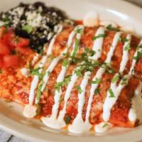 Chicken Enchiladas · Slow-cooked chicken with bacon, jalapeños, cheese, and sour cream in a red chili sauce serve...