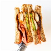 Coastal Chicken Club · Grilled Chicken, housemade bacon jam, fresh avocado, tomato, and Swiss cheese sandwiched bet...