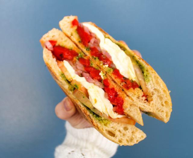 Caprese Panini · Fresh mozzarella, tomatoes, pickled red onions, roasted red peppers and pesto. served with a side of balsamic vinaigrette.