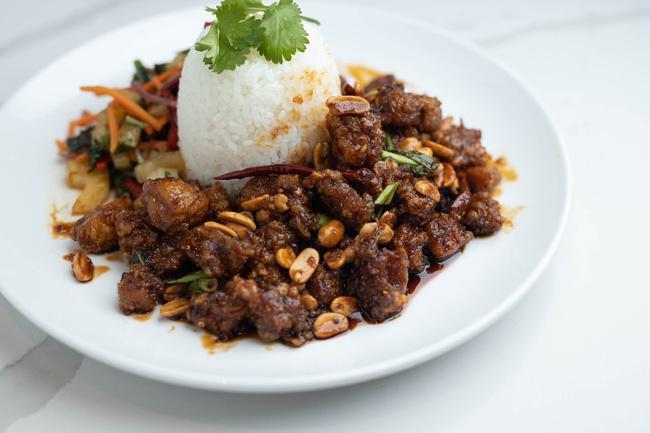Kung Pao Chicken · Spicy soy ginger glaze and Sambal chili tossed with chicken, green onions, peanuts, dried red chilies, garlic, ginger and cilantro. Served with steamed white rice and a sautéed Thai vegetable mixture.