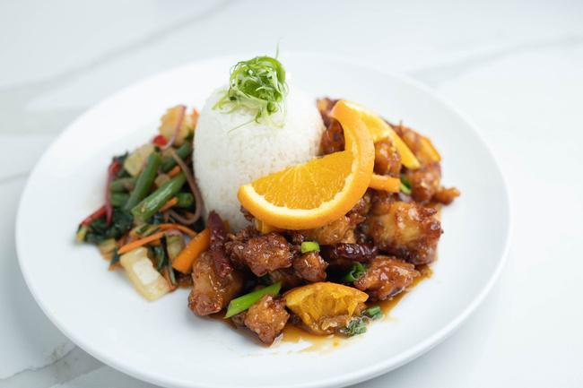 Szechaun Orange Chicken · Tempura fried chicken tossed in soy orange glaze with garlic, ginger, dried chilies, green onions and fresh orange slices. Served with steamed white rice and a sautéed Thai vegetable mixture.