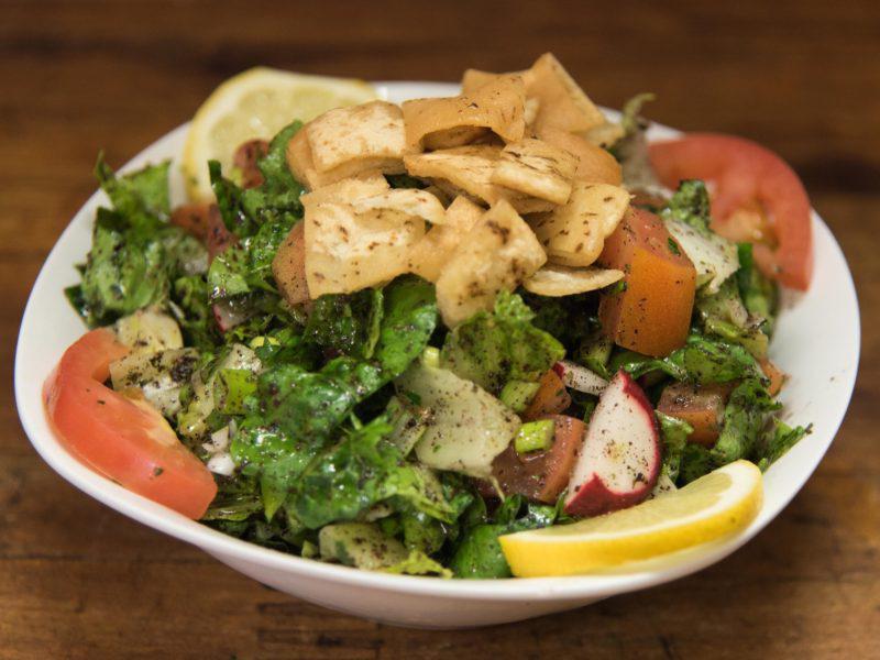 Fattoush Salad فتوش · Lettuce, tomatoes, cucumber, radish, green onions, and mint, seasoned with olive oil and lemon juice. Topped with toasted pita bread.