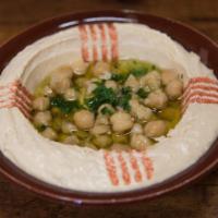 Hummus حـمص · A creamy dip of chickpeas, tahini, lemon and garlic. Topped with olive oil.