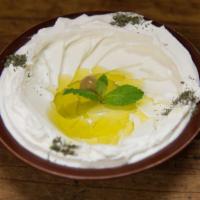 Tzatziki خيـار مع لـبن · Chopped cucumber and yogurt, seasoned with garlic and dried mint.