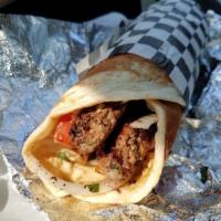 13. Tri-Meat Wrap لحم ودجاج صاج · Chicken, lamb, beef mixed with parsley, tomato, lettuce, onion, and Mediterranean spices. Hu...