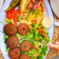 32. Falafel over Salad فلافل مع السلطة · Salad with fried balls made from beans. 