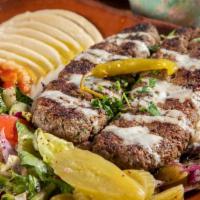 27. Kafta Kabab over Rice Plate · Ground beef with chopped onion and parsley seasoned with a blend of spices, rice, mix salad,...