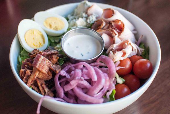 Stella's Cobb Salad · Point Reyes blue cheese, organic mixed greens, egg, organic cherry tomatoes, pickled red onions, chicken and bacon.