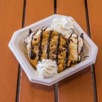 Warm Brownie Sundae · A rich homemade chocolate brownie warmed to order, topped with pecans, vanilla ice cream, dr...