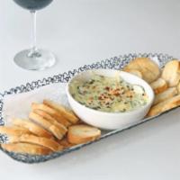 Spinach Artichoke Dip · Creamy spinach and artichoke dip topped with melted Parmesan cheese. Served with House Made ...