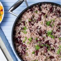 Rice and Peas · Trini rice and peas—seasoned with the special trinity of thyme, scallion, and garlic—is a st...