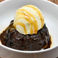 Chocolate Bourbon Cake · House baked Woodford Reserve reduction soaked chocolate cake topped with caramel sauce.